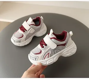 Close-up of breathable mesh toddler sneakers with soft sole and velcro closure.