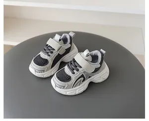 Macro view of breathable mesh children's chunky sneakers with secure Velcro straps