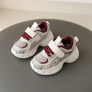 Breathable children's sports sneakers in grey and burgundy accents with chunky soles.
