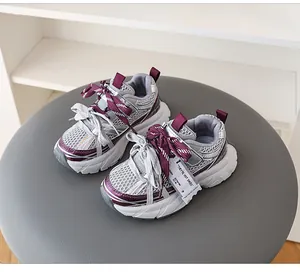 Detail view of kids' mesh breathable sneakers in grey and purple with double laces.
