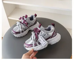 Side detail of kids' chunky sneakers featuring purple mesh and double laces design