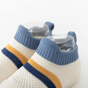 Detailed view of breathable knit baby walking shoes with blue and yellow stripes