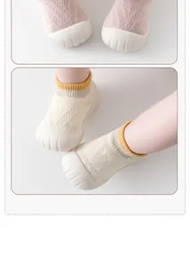 Detailed view of breathable knit baby walker socks with non-slip rubber soles in two colors