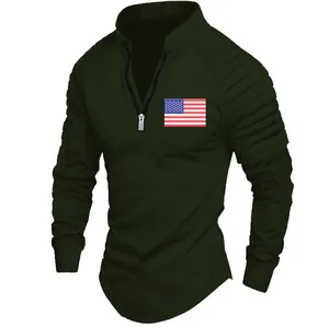 Detailed view of dark green polo shirt featuring pleated sleeves and a US flag
