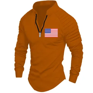 Detail of men's orange long-sleeved polo with pleated sleeves and American flag