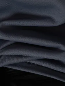 Close-up macro view showing the breathable textured fabric of a men's sports polo shirt.