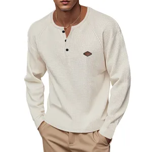 Close-up detail of men's cream waffle-knit Henley shirt with three-button neckline.