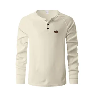 Detail of men's long sleeve Henley shirt featuring cream waffle knit texture and buttons.
