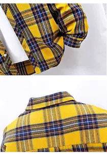 Detailed macro view showing the collar and cuff of a high-quality yellow plaid shirt