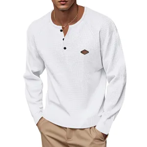 High-quality detail of men's white waffle knit long-sleeve Henley shirt with black buttons