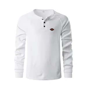 Close-up detail view of white waffle knit long sleeve Henley shirt with buttons for men
