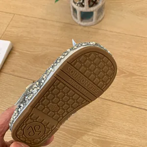 Detailed view of sparkly silver sequin girls' princess shoe with a non-slip rubber sole