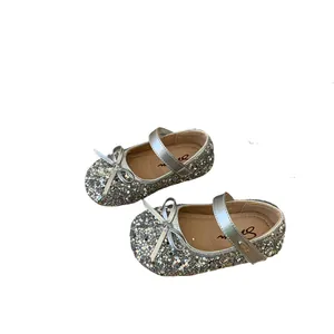 Sparkly silver girls' princess shoes with adorable bow detail and adjustable strap