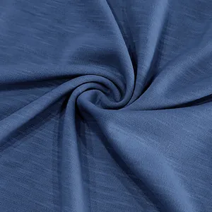 Close-up detail of premium blue slub cotton fabric texture for men's T-shirts.