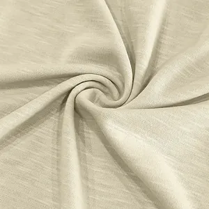 Detailed close-up view of beige slub cotton fabric showing soft texture and vintage drape.