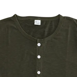 Close-up of olive green Henley T-shirt neckline featuring buttons and slub cotton texture