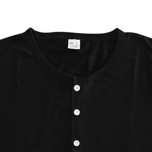 Close-up detail of a black Henley neck t-shirt featuring white buttons and slub cotton texture