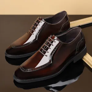 Elegant men's brown polished leather Brogue shoes with classic decorative perforations