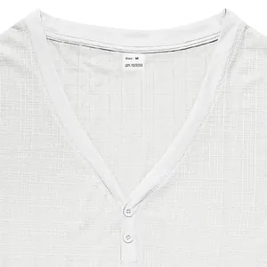 Close-up of white breathable slub texture Henley shirt neckline with buttons