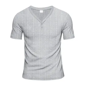 Macro view of grey Henley t-shirt featuring grid texture and two-button neckline