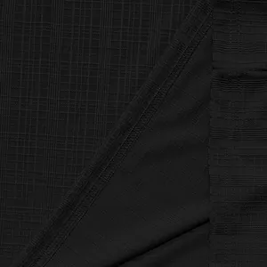 Macro view of the breathable black slub texture fabric on this casual men's summer shirt.
