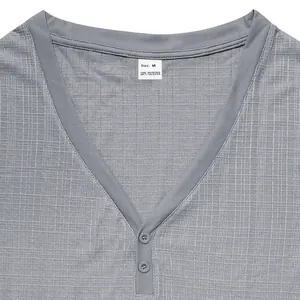 Close-up view of a grey Henley t-shirt neckline showing fabric texture and size tag