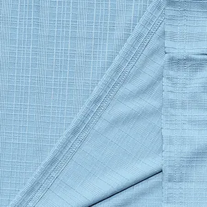 Close-up view of light blue slub texture fabric showing breathable material and stitching