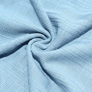 Detailed macro view of the light blue slub texture breathable fabric for men's Henley shirt