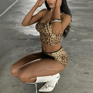 Model wearing a leopard print two-piece set with a slim-fit camisole and matching shorts.