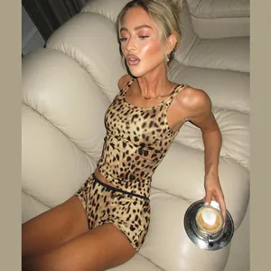 Detail of women's leopard print slim fit tank top and shorts set worn by model on sofa