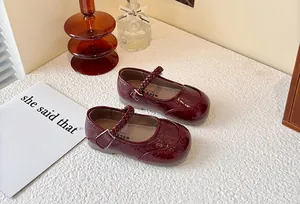 Wine red girls' Mary Jane shoes with braided straps and glossy crinkled texture.