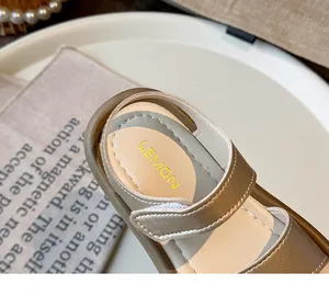 Close-up detail of golden girls sandals with Velcro strap and Lemon logo insole