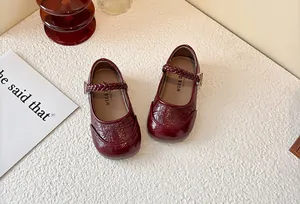 Top view of girls burgundy patent leather Mary Jane shoes with braided strap detail
