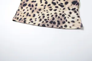 Detailed macro view of leopard print ribbed knit fabric showing quality hem stitching.