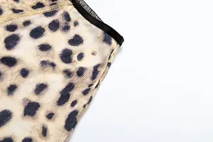 Close-up of leopard print ribbed fabric showing detailed stitching and black trim