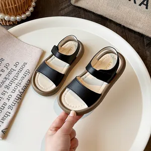 Stylish black and beige girls' sandals with soft chunky soles and convenient Velcro straps.