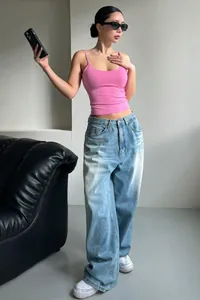 Stylish pink minimalist backless camisole top paired with light wash denim jeans