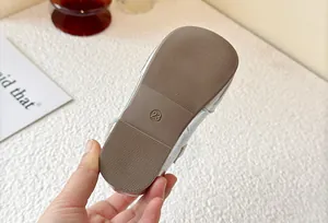Close-up of children's silver princess shoe sole with size 23 and anti-slip grip