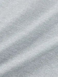 Close-up of grey waffle knit fabric showing breathable texture for men's casual t-shirt.