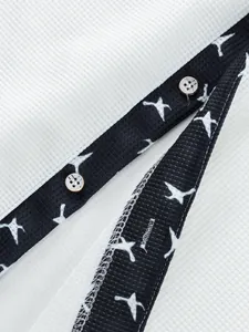 Close-up of men's waffle knit shirt placket with bird print trim and buttons