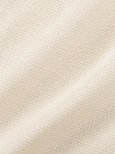 Extreme close-up showing the soft and breathable waffle knit texture of a men's t-shirt