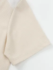 Close-up detail of cream waffle knit fabric on men's short sleeve cardigan t-shirt