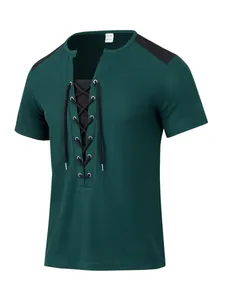 Detailed view of dark green waffle knit t-shirt with black lace-up front and metal eyelets.