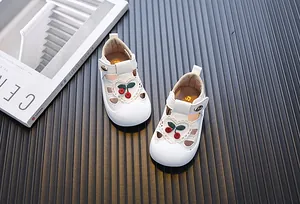 Detailed view of white toddler girl sandals with cute cherry embroidery and hollow soft soles