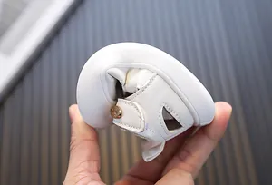 Detail view showing the extreme flexibility and soft sole of white toddler girl sandals