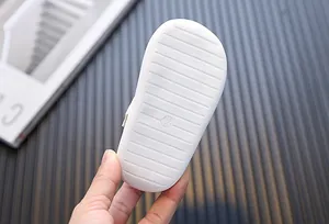 Detailed macro view of the soft white anti-slip sole of girls' toddler walking shoes