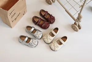 Detailed view of children's pleated Mary Jane shoes in multiple colors with bows