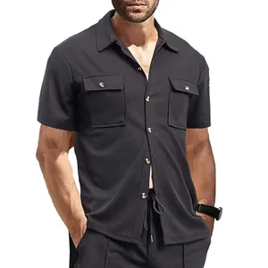 Detail shot of men's black waffle knit shirt featuring dual chest pockets and lapel collar