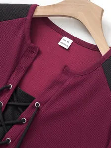 Macro close-up of waffle knit texture and lace-up neckline on men's casual t-shirt