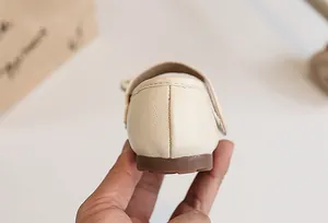 Detailed macro view of the heel and stitching on beige children's soft leather princess shoes